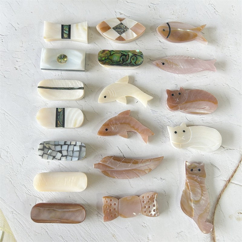 Collection of variously shaped and sized stone carvings on a light surface